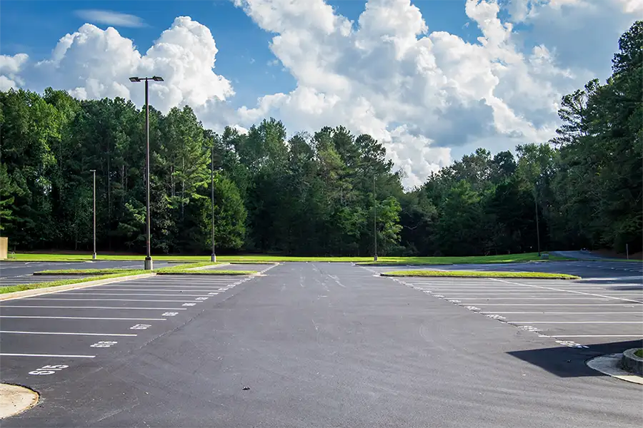 Recently paved asphalt parking lot with numbered painted spaces - beautiful summer day - Chatham, IL