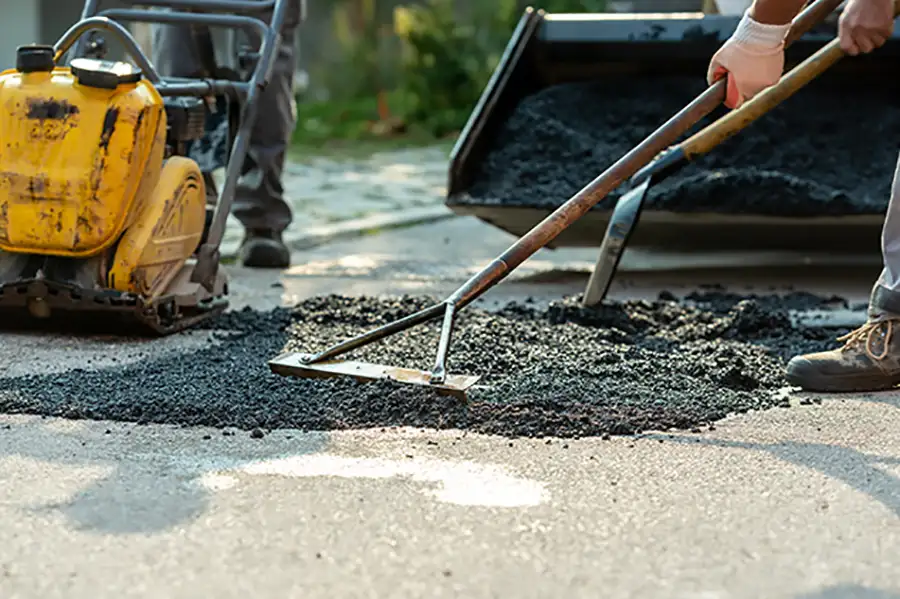 Asphalt services - cut and patch pot holes in the road - tamping down hot asphalt - Chatham, IL